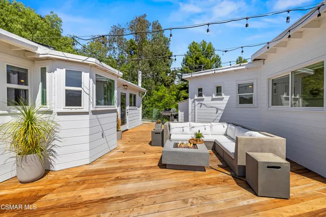a backyard of a house with lots of green space and lake view