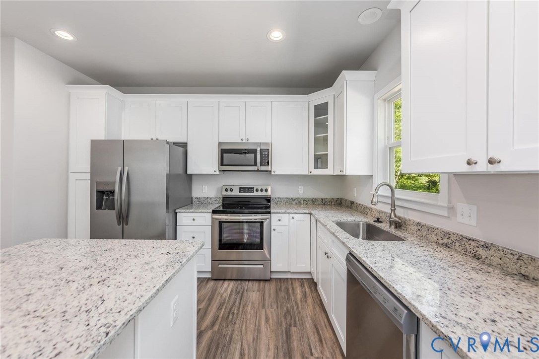 200 Victoria Drive Ruther Glen, VA 22546 - Photo 14 of 30 a kitchen with stainless steel appliances granite countertop a sink stove microwave and refrigerator