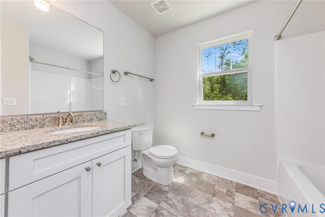 200 Victoria Drive Ruther Glen, VA 22546 - Photo 26 of 30 a bathroom with a granite countertop toilet sink and mirror