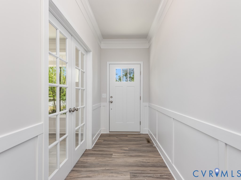 200 Victoria Drive Ruther Glen, VA 22546 - Photo 3 of 30 a view of a hallway with wooden floor and windows