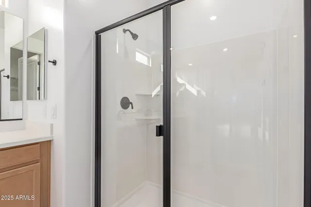 a bathroom with a glass shower door and a shower