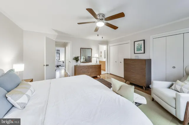 a bed room with a bed and a ceiling fan