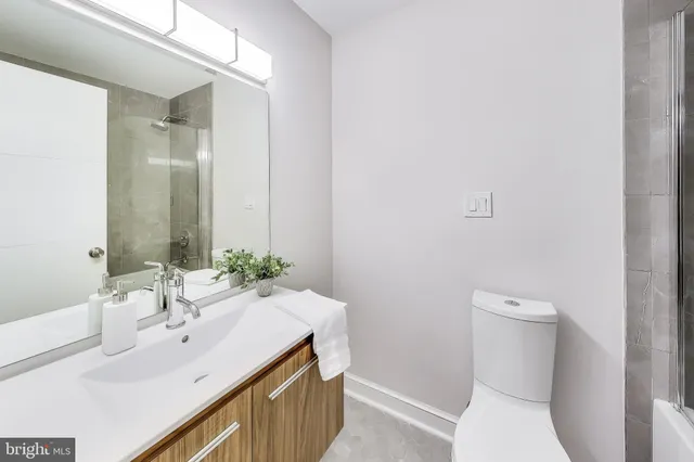a bathroom with a sink toilet and mirror