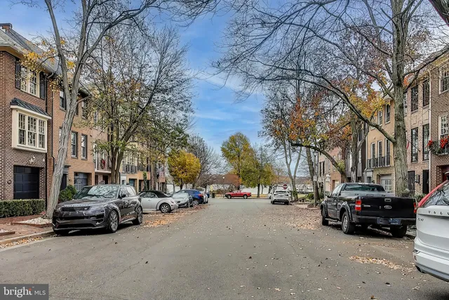 a view of a patio with couches and a table and chairs with wooden floor