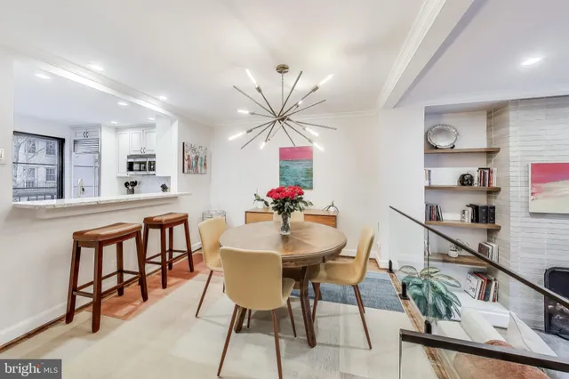 a view of a dining room with furniture and a kitchen