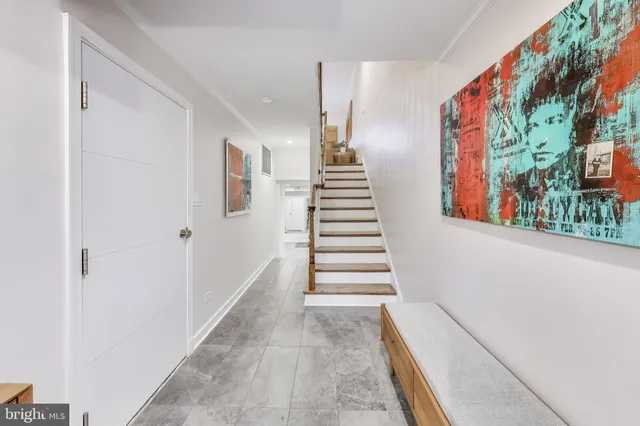 a view of entryway with furniture and stairs
