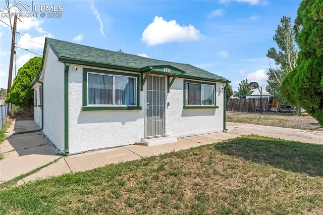 a front view of a house with a garden