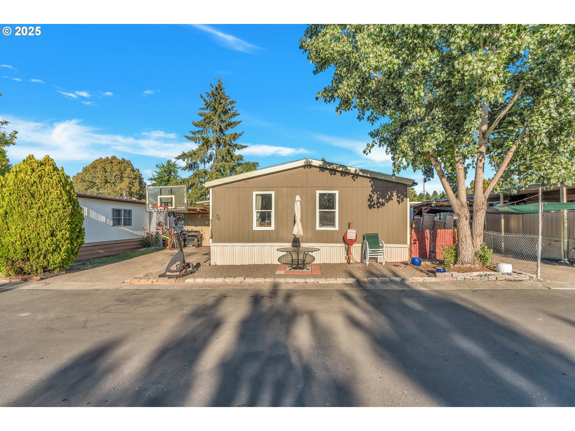 a backyard of a house with table and chairs