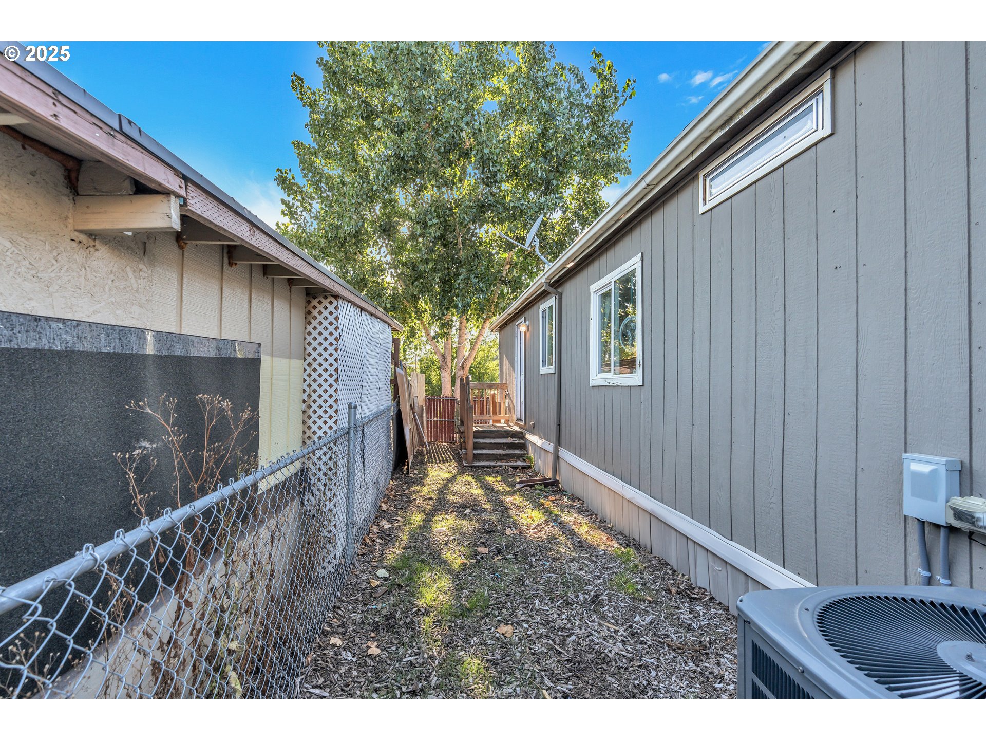 5885 Northeast Jacobson Street, Unit 70 Hillsboro, OR 97124 - Photo 23 of 29 a backyard of a house with lots of green space