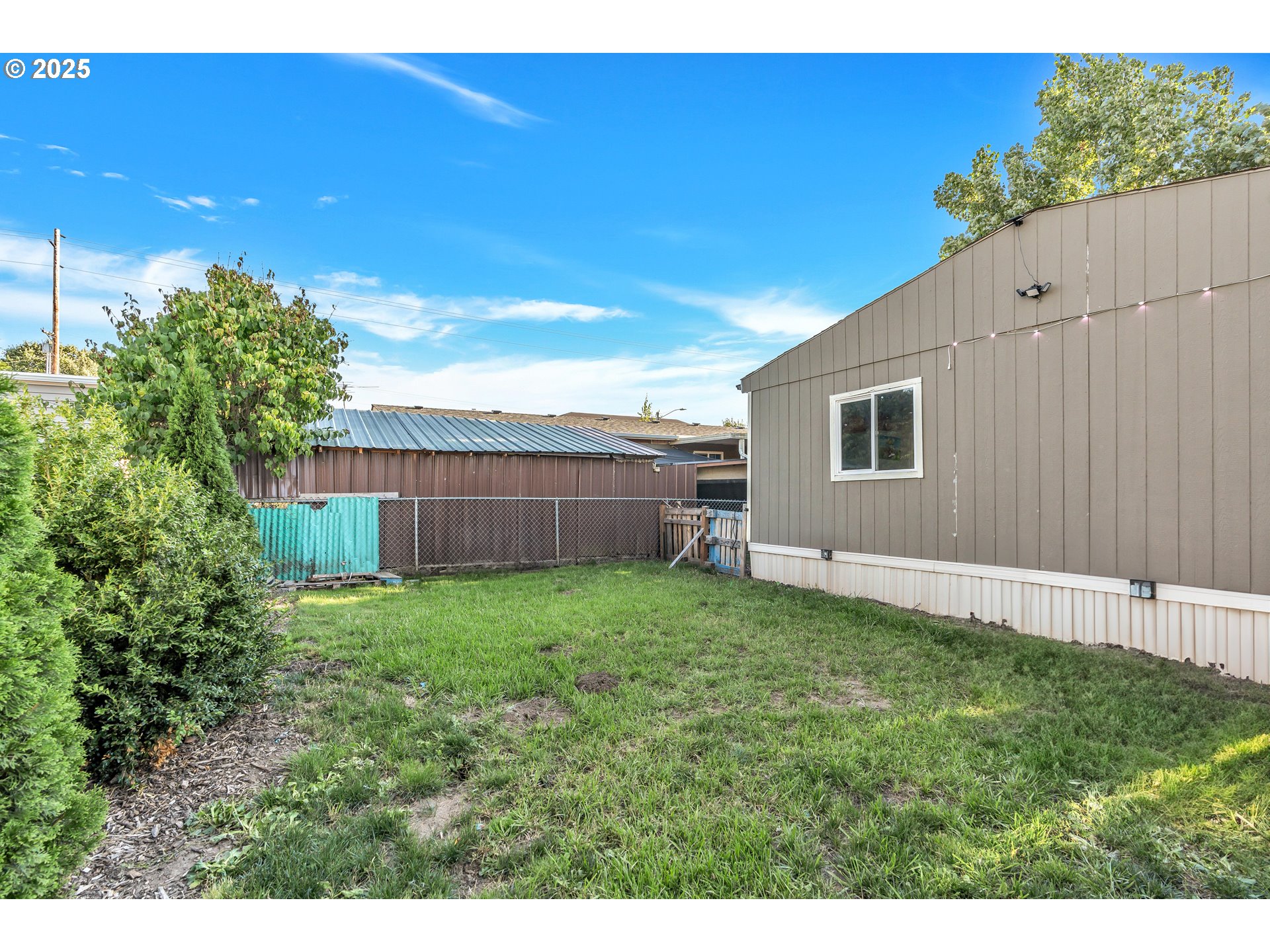5885 Northeast Jacobson Street, Unit 70 Hillsboro, OR 97124 - Photo 25 of 29 a view of a backyard with plants and a garden