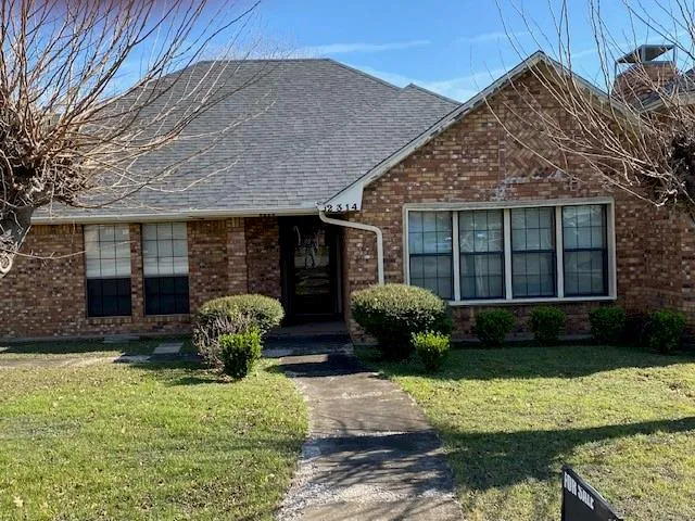 a front view of a house with garden and porch