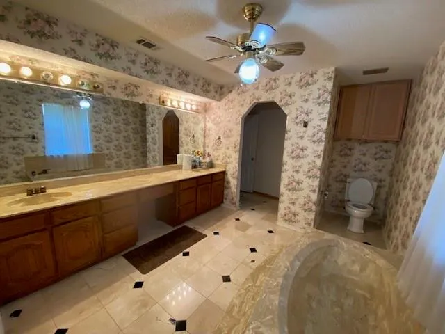a bathroom with a sink a large mirror and a shower