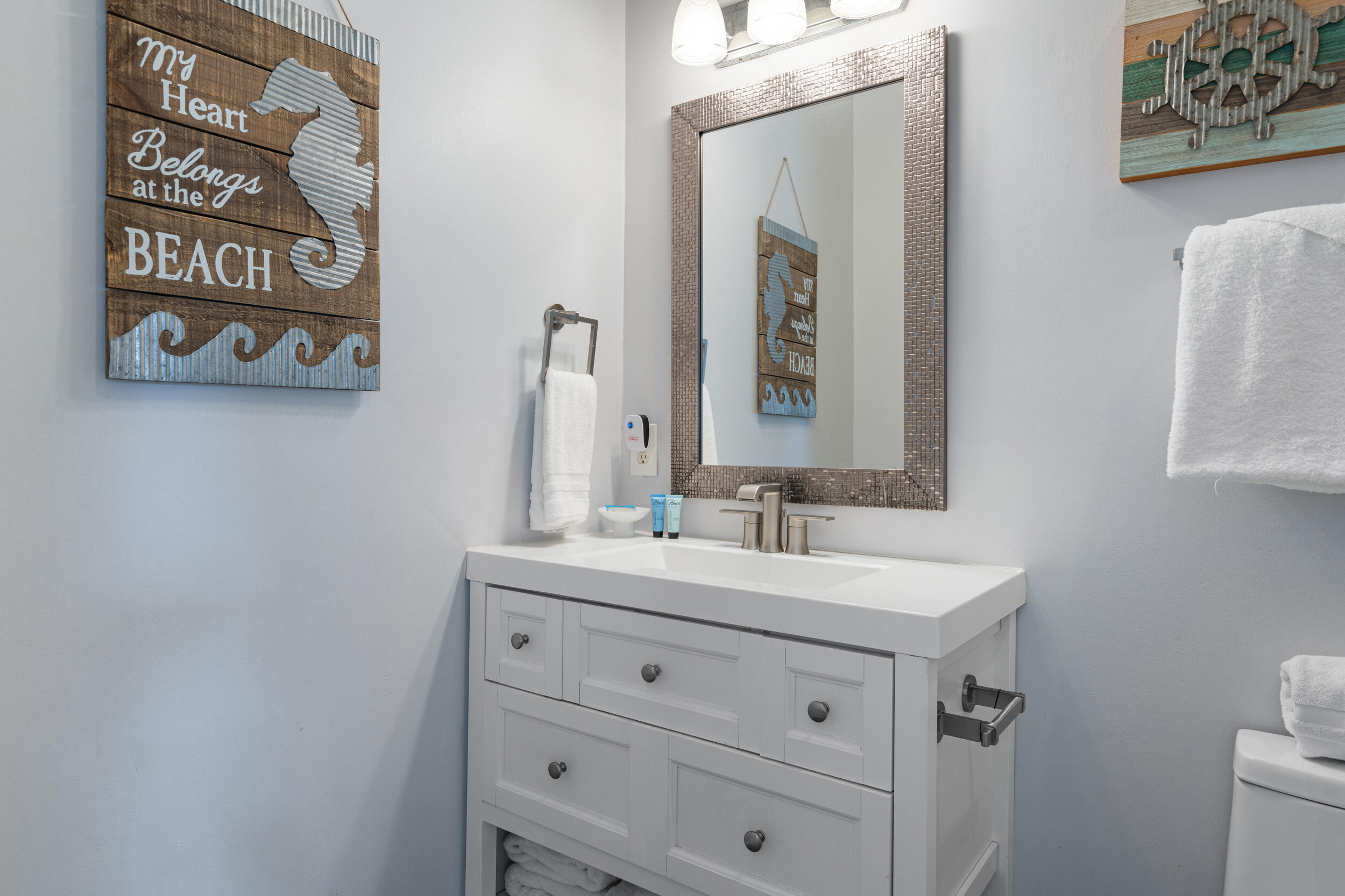 17878 Front Beach Road, Unit E2 Panama City Beach, FL 32413 - Photo 14 of 34 a bathroom with a sink and a mirror