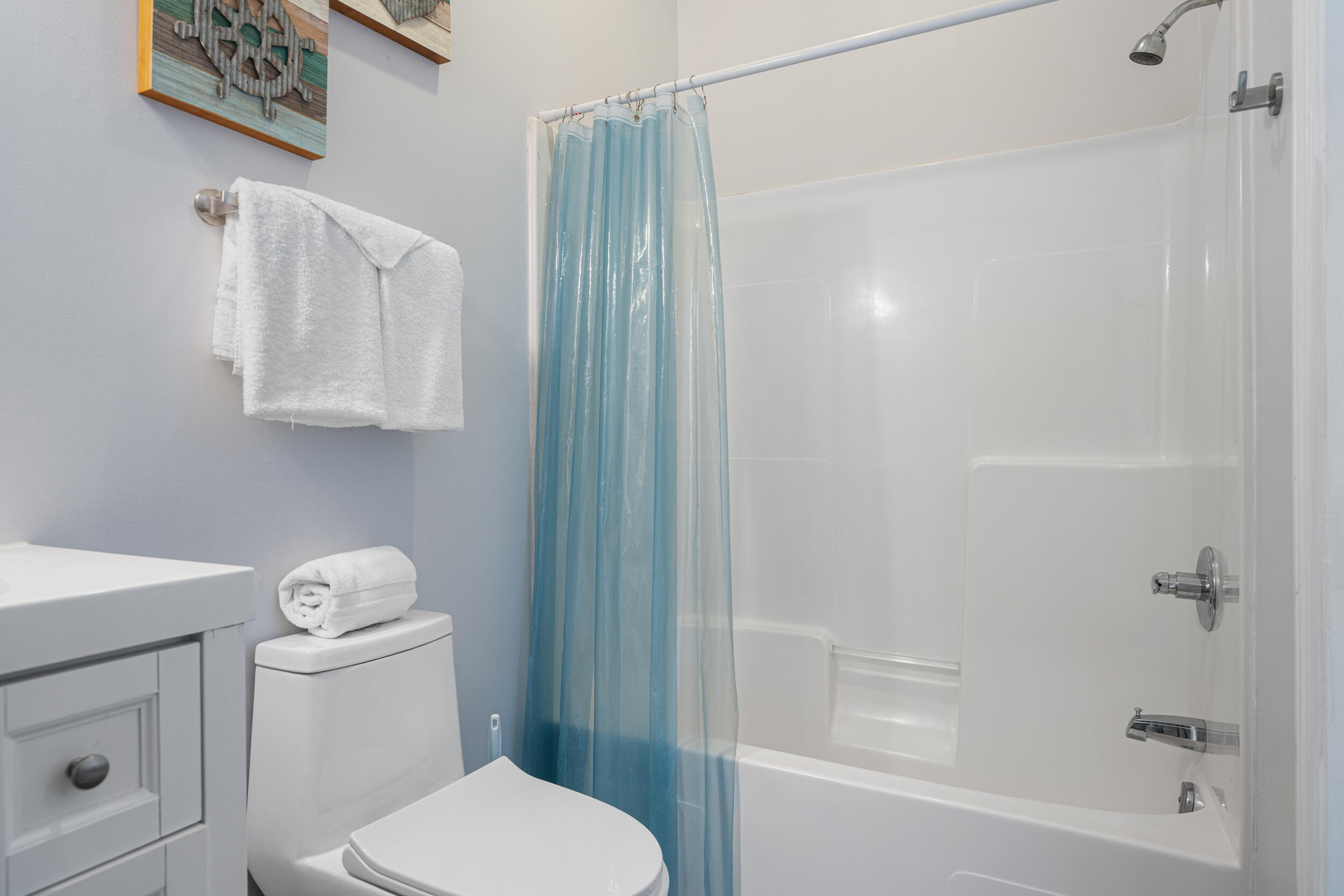 17878 Front Beach Road, Unit E2 Panama City Beach, FL 32413 - Photo 15 of 34 a white toilet sitting next to a bath tub