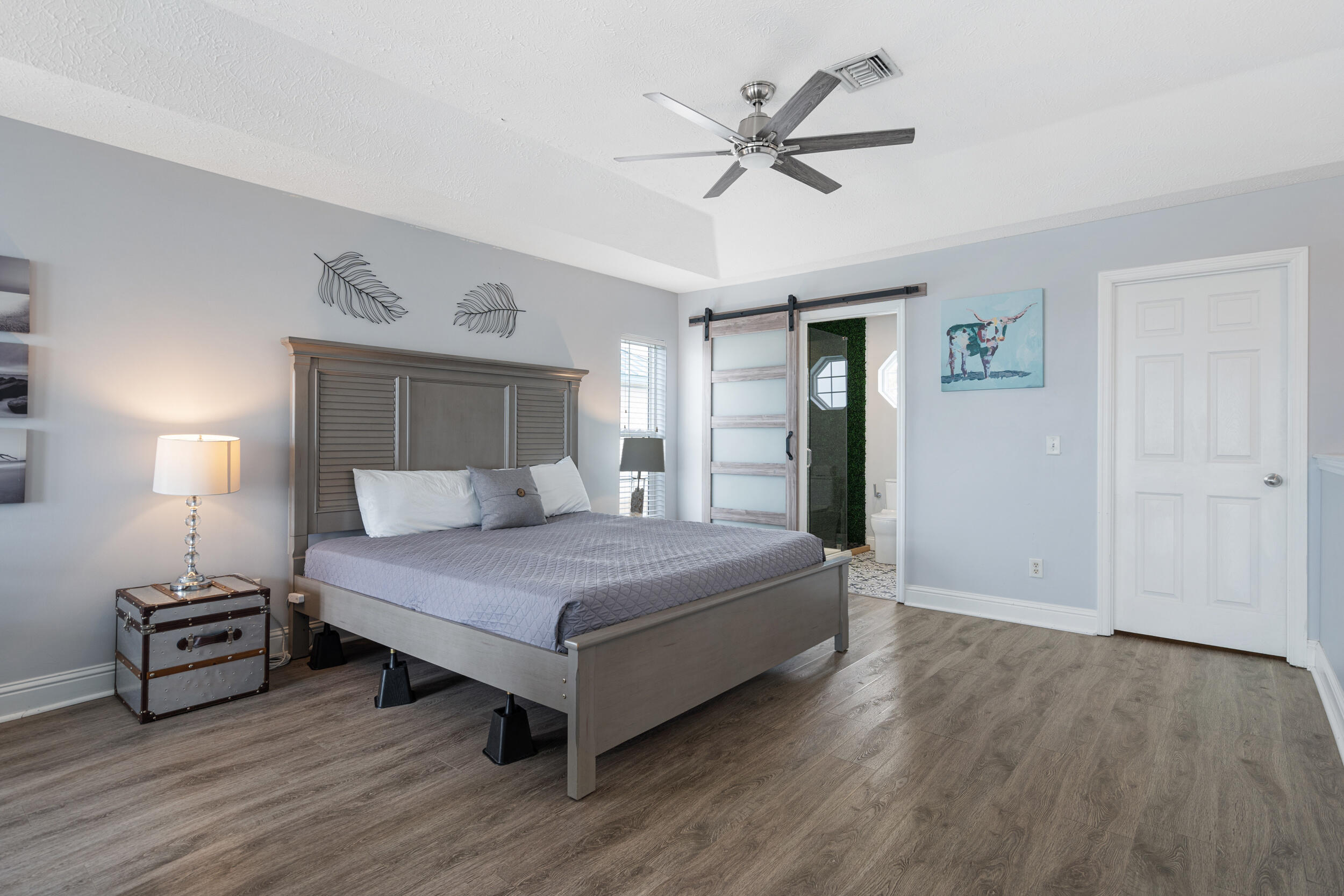17878 Front Beach Road, Unit E2 Panama City Beach, FL 32413 - Photo 20 of 34 a bedroom with a bed and a chandelier