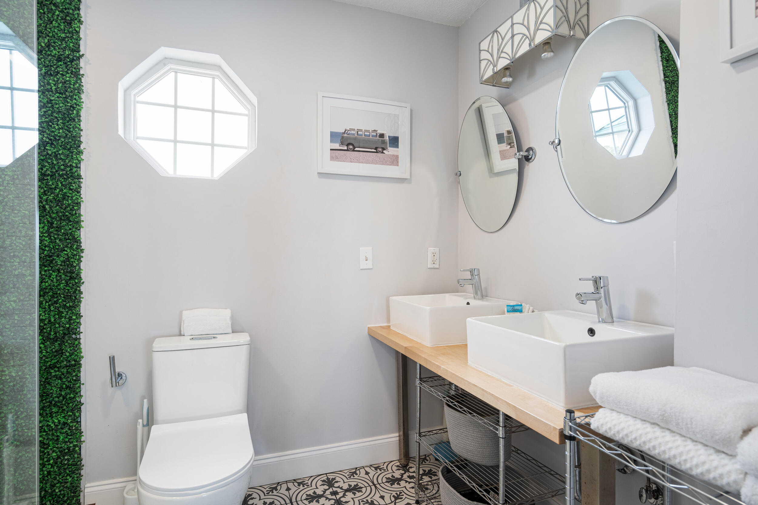17878 Front Beach Road, Unit E2 Panama City Beach, FL 32413 - Photo 21 of 34 a bathroom with a toilet a sink and mirror