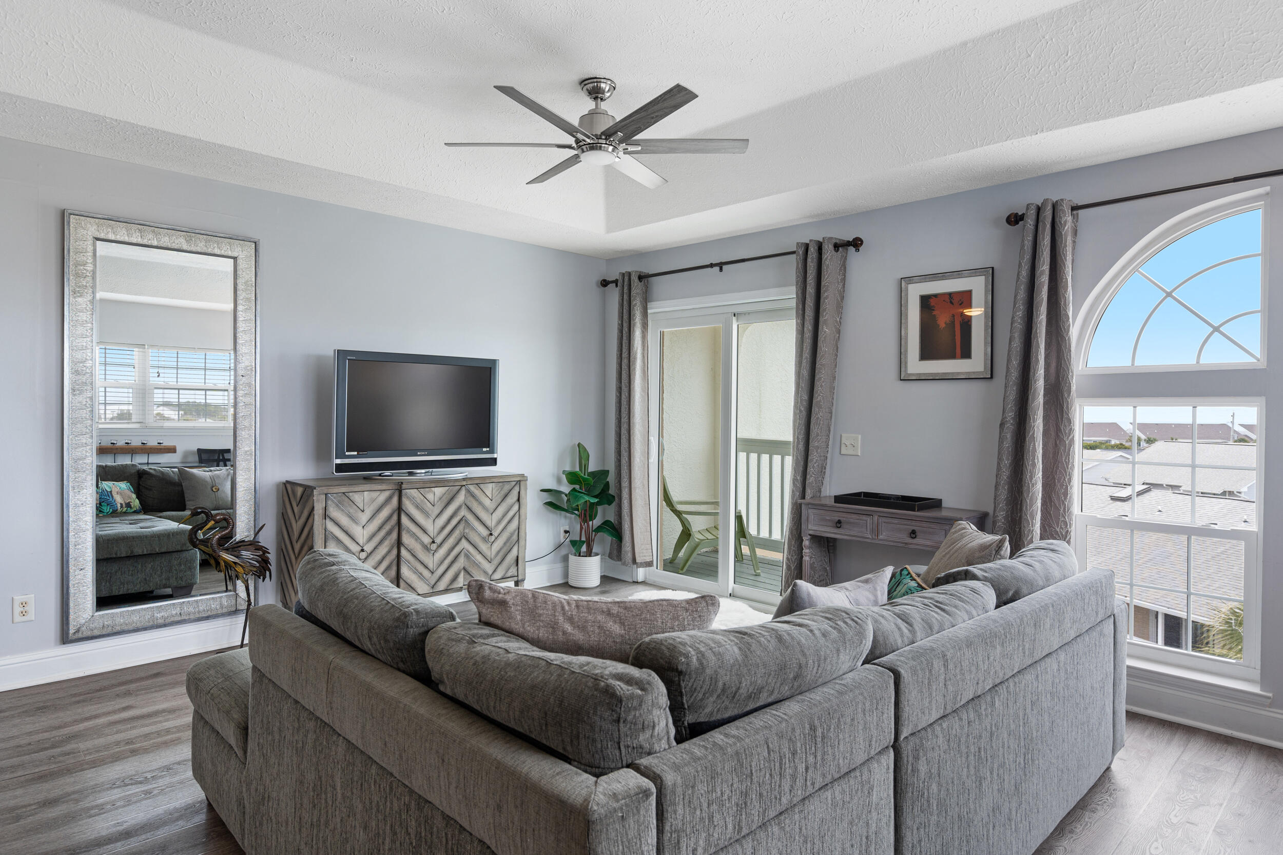 17878 Front Beach Road, Unit E2 Panama City Beach, FL 32413 - Photo 23 of 34 a living room with furniture and a flat screen tv
