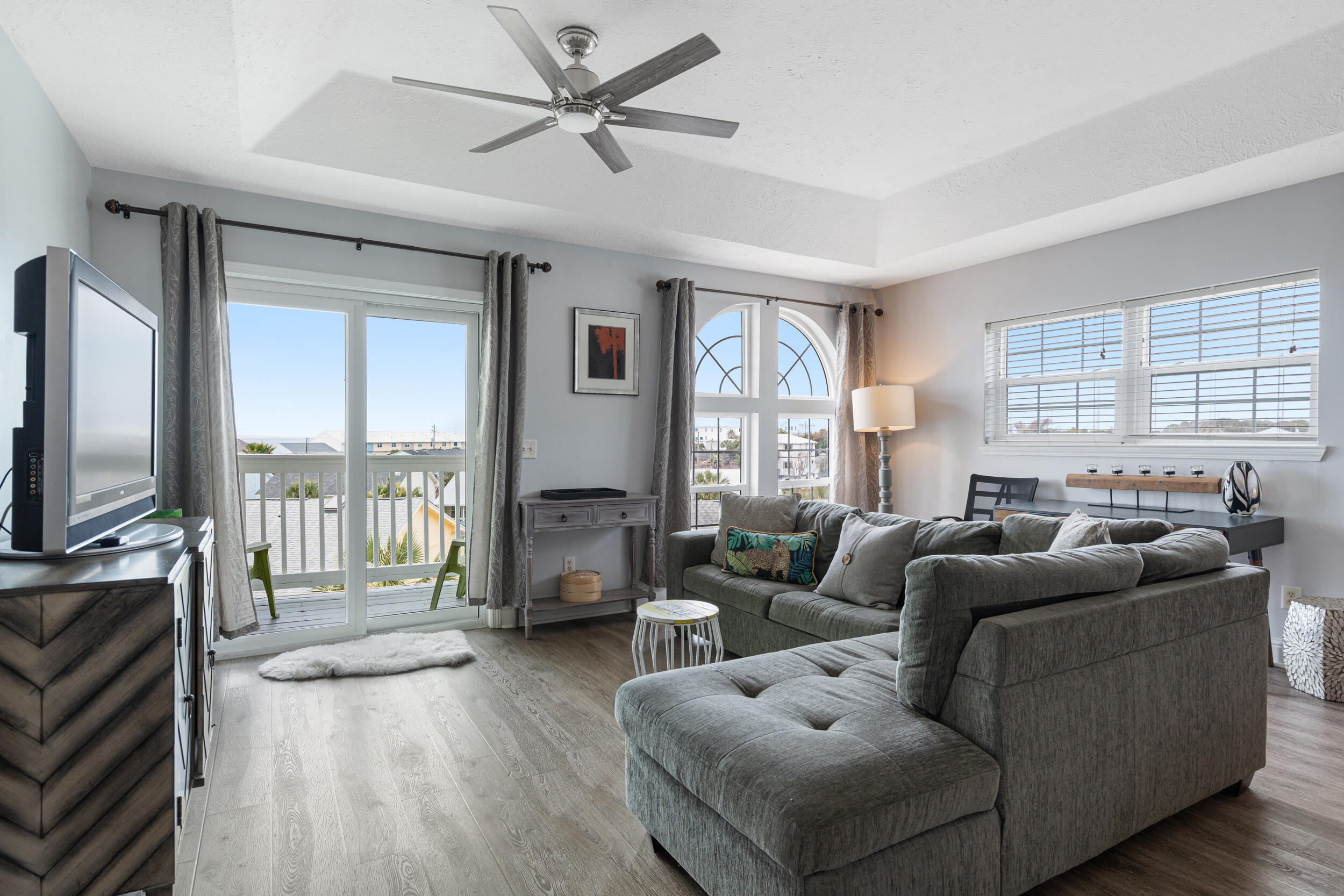 17878 Front Beach Road, Unit E2 Panama City Beach, FL 32413 - Photo 24 of 34 a living room with furniture and a flat screen tv