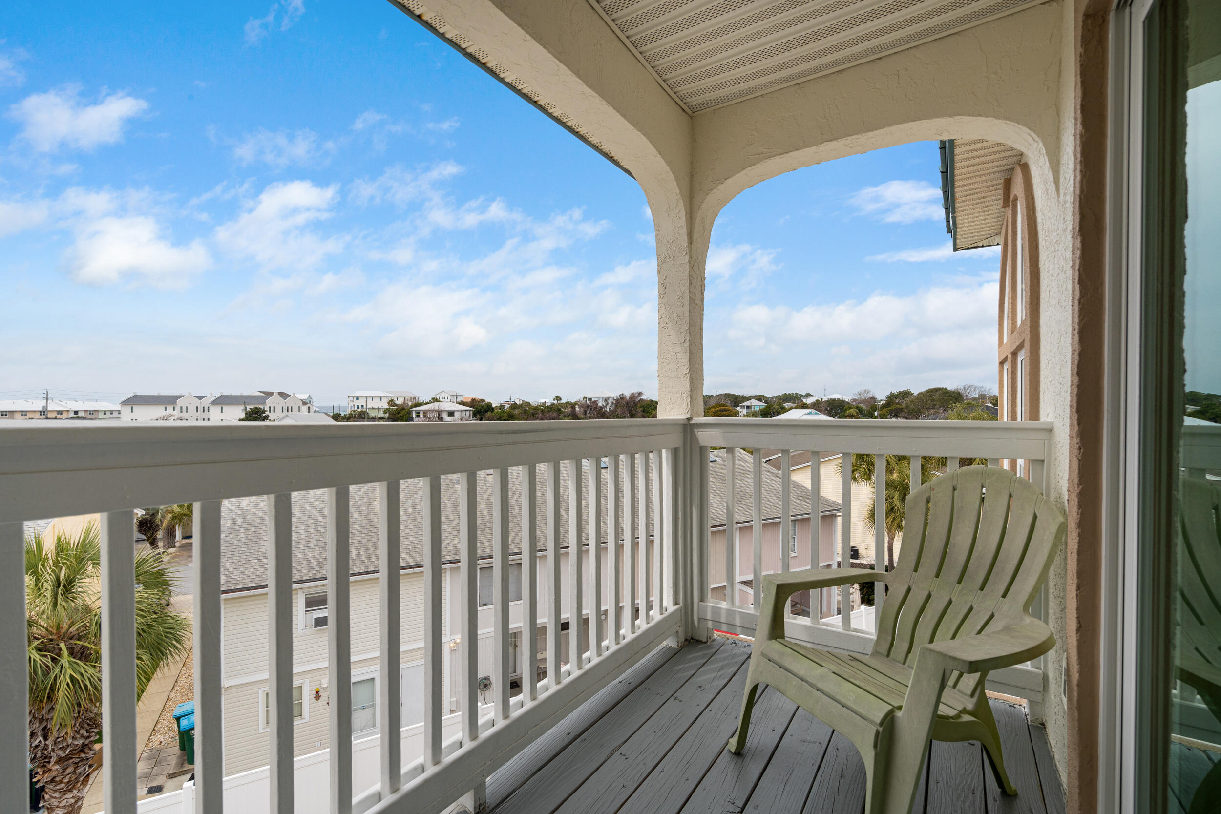 17878 Front Beach Road, Unit E2 Panama City Beach, FL 32413 - Photo 26 of 34 a view of a balcony with wooden floor & fence