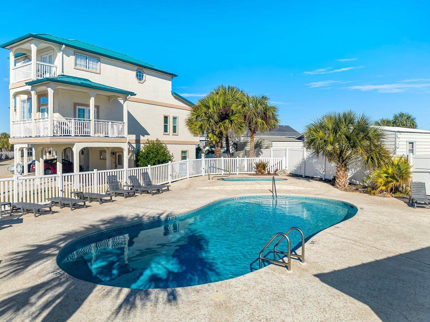 17878 Front Beach Road, Unit E2 Panama City Beach, FL 32413 - Photo 3 of 34 a view of a house with backyard and sitting area
