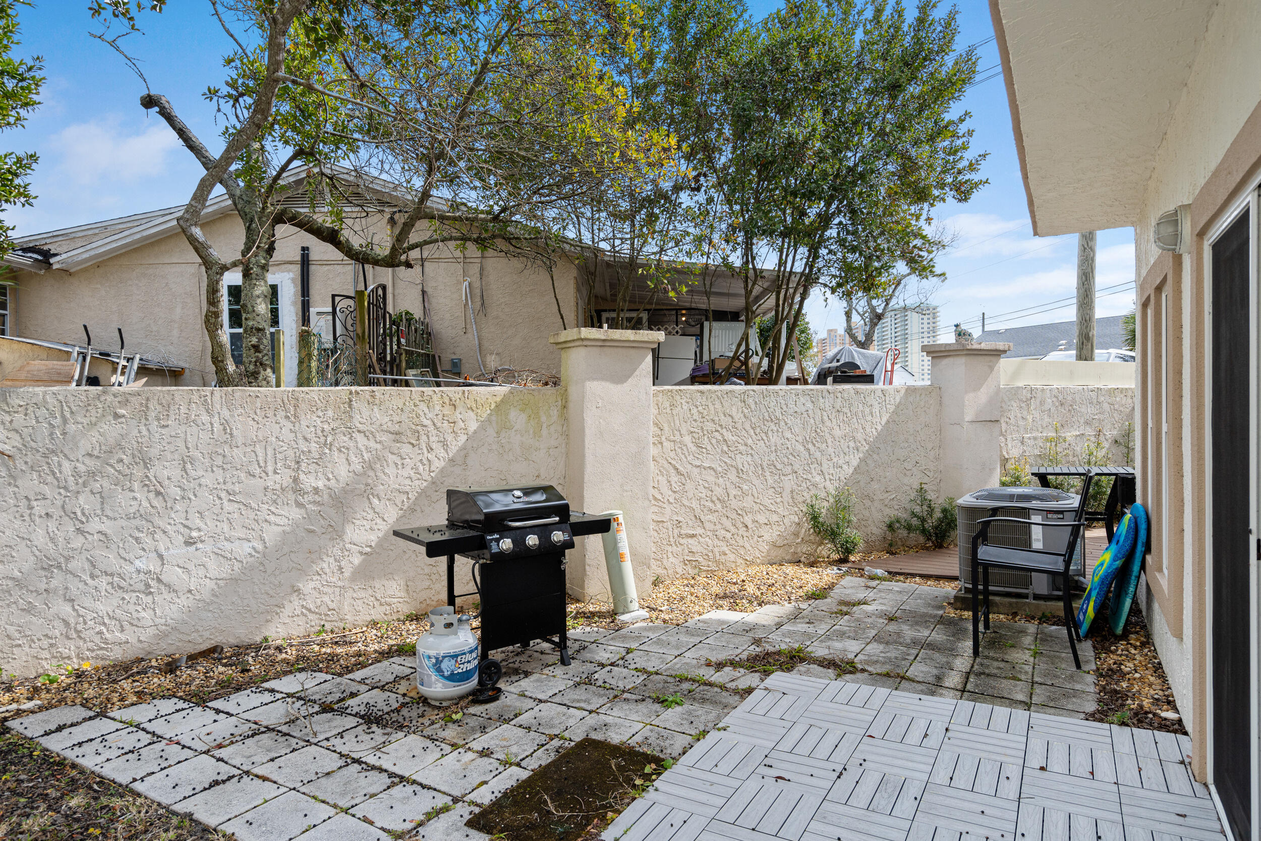 17878 Front Beach Road, Unit E2 Panama City Beach, FL 32413 - Photo 32 of 34 a backyard of a house with barbeque oven