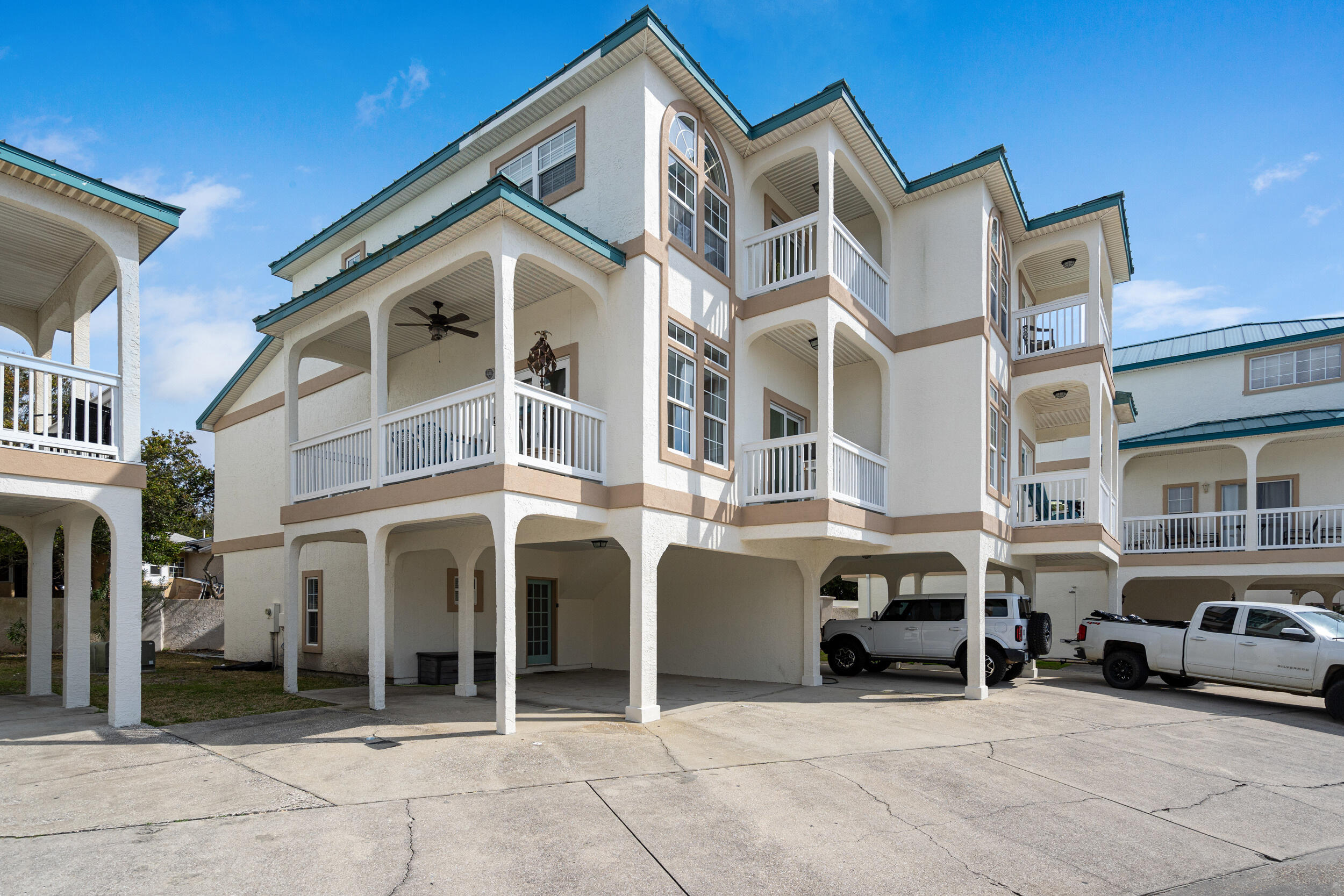 17878 Front Beach Road, Unit E2 Panama City Beach, FL 32413 - Photo 4 of 34 a view of a white building with outdoor seating space
