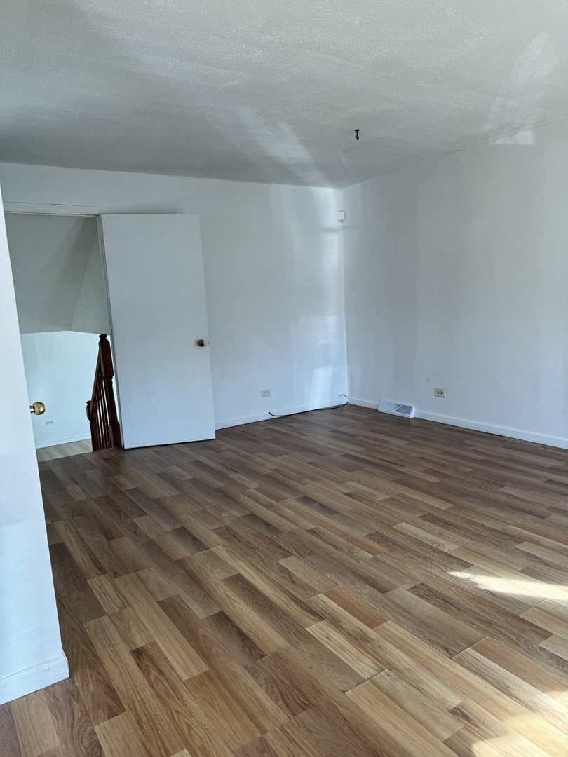 14543 Cooper Avenue Dixmoor, IL 60426 - Photo 1 of 14 a view of empty room with wooden floor