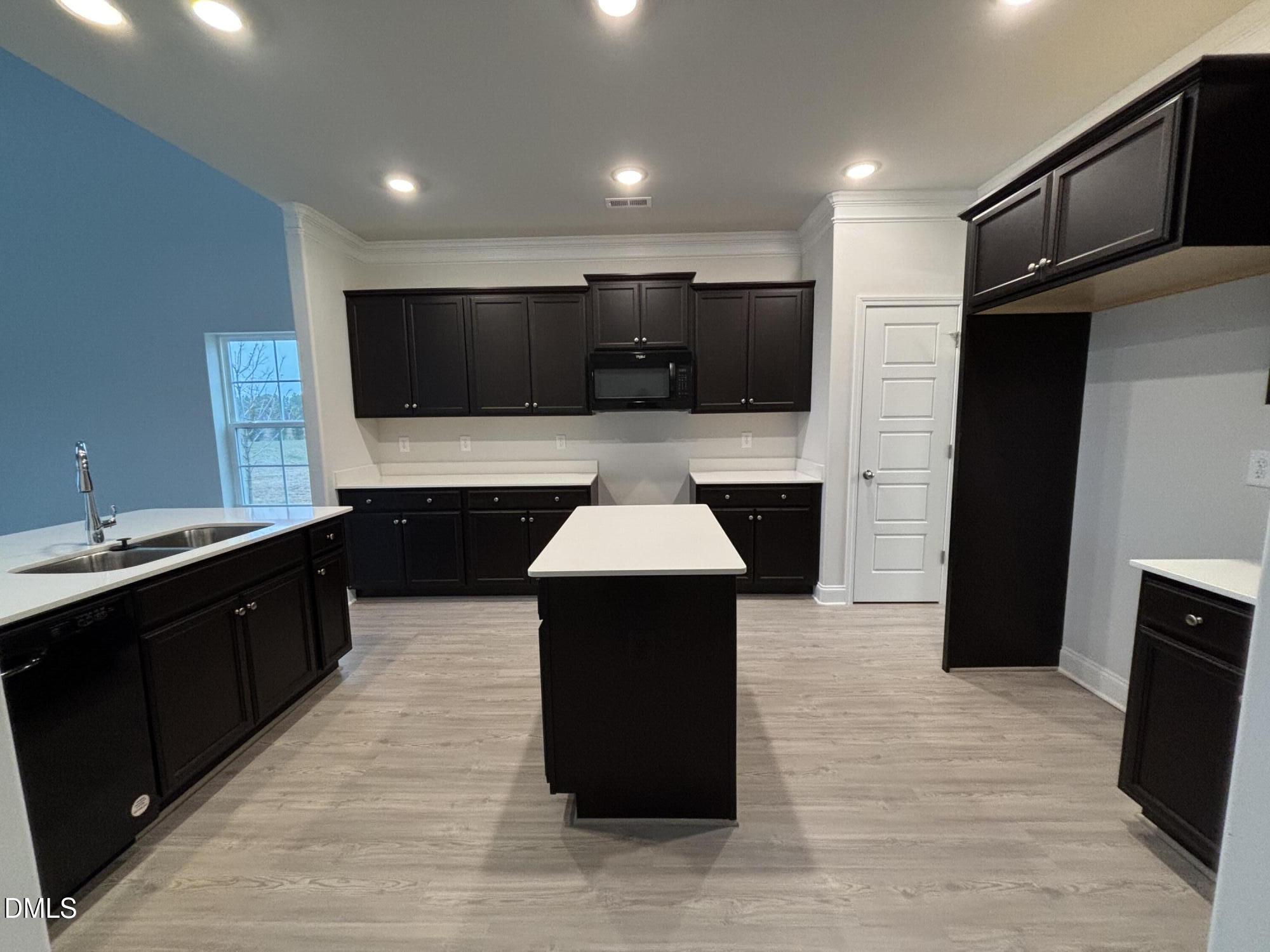 1911 Darrell Drive, Unit 4 Graham, NC 27253 - Photo 4 of 14 a kitchen with a sink and a stove top oven