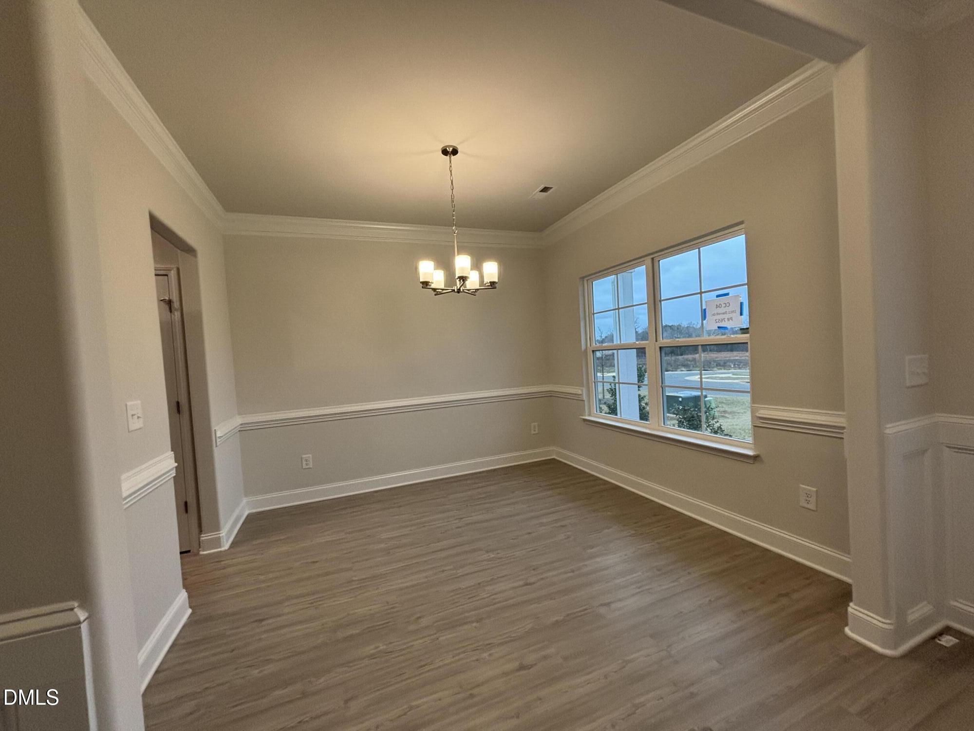 1911 Darrell Drive, Unit 4 Graham, NC 27253 - Photo 5 of 14 an empty room with wooden floor and windows