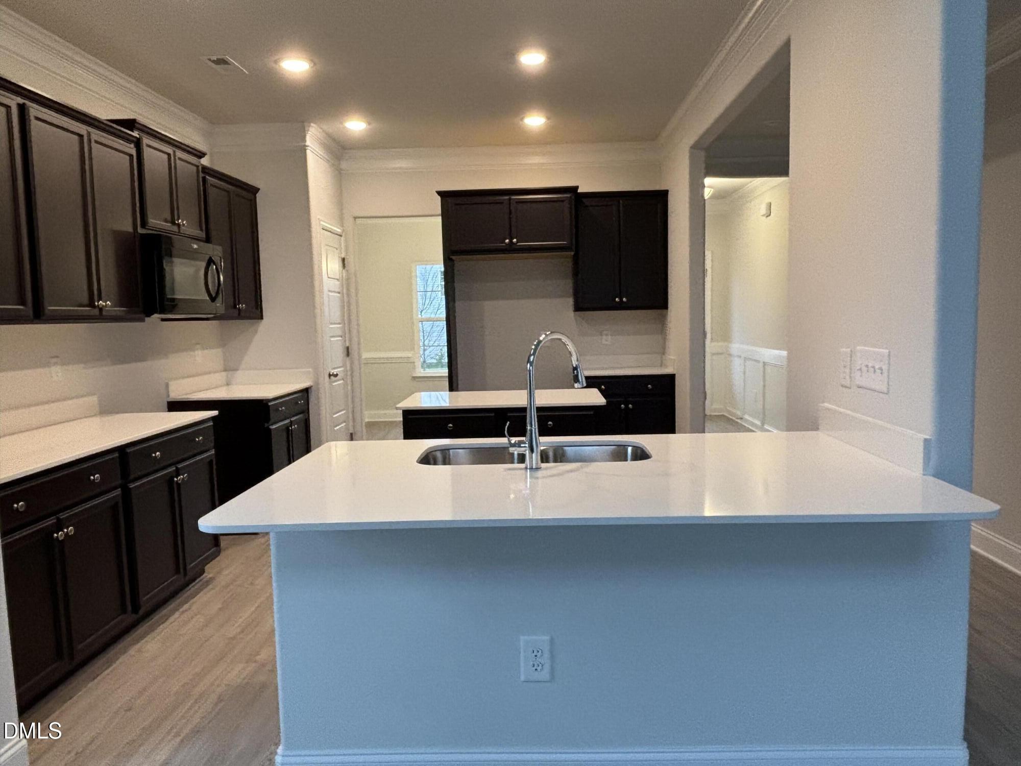 1911 Darrell Drive, Unit 4 Graham, NC 27253 - Photo 6 of 14 a large kitchen with stainless steel appliances a large counter top a stove a refrigerator and a sink