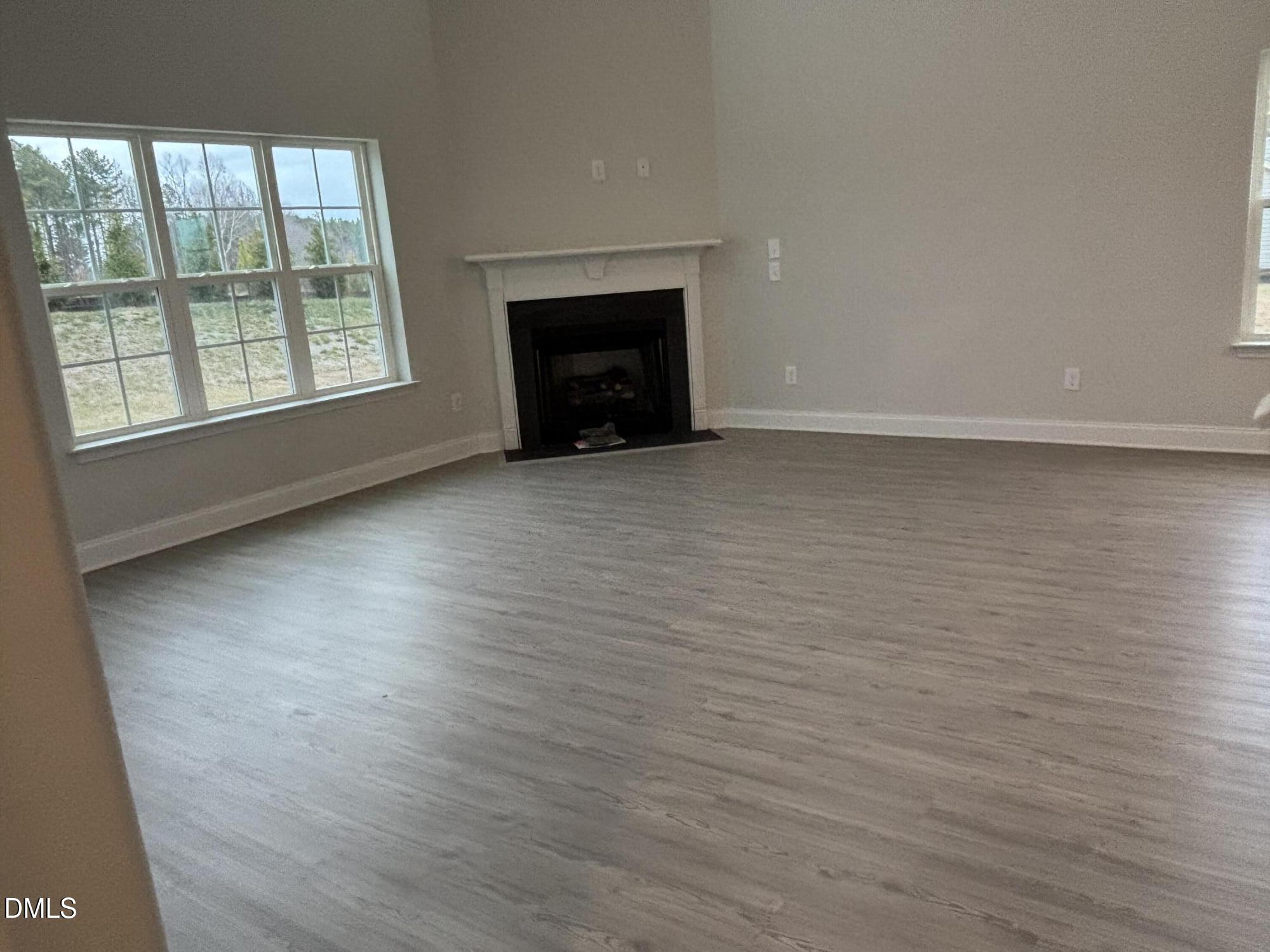 1911 Darrell Drive, Unit 4 Graham, NC 27253 - Photo 7 of 14 a view of an empty room with a window and fireplace
