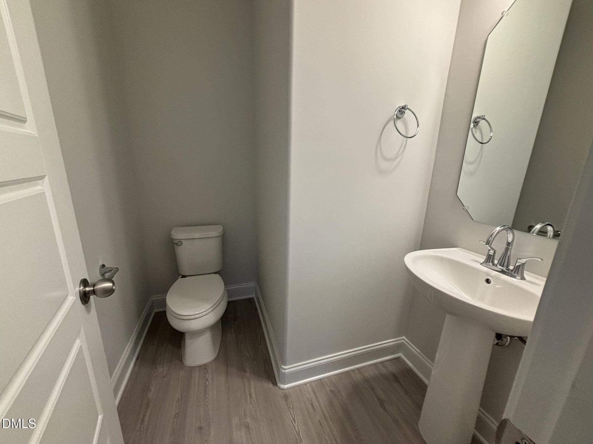 1911 Darrell Drive, Unit 4 Graham, NC 27253 - Photo 9 of 14 a bathroom with a toilet sink and mirror