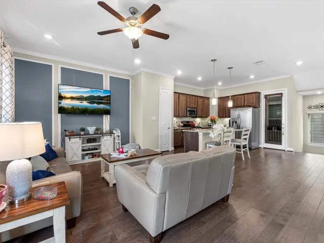 a living room with fireplace furniture and a flat screen tv