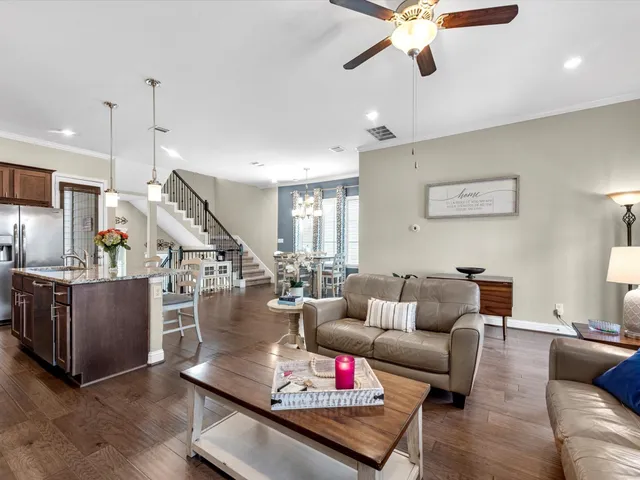 a living room with furniture and kitchen view