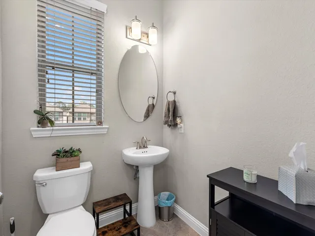 a bathroom with a toilet a sink and a mirror