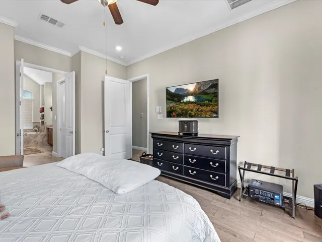 a bedroom with a bed and a flat screen tv