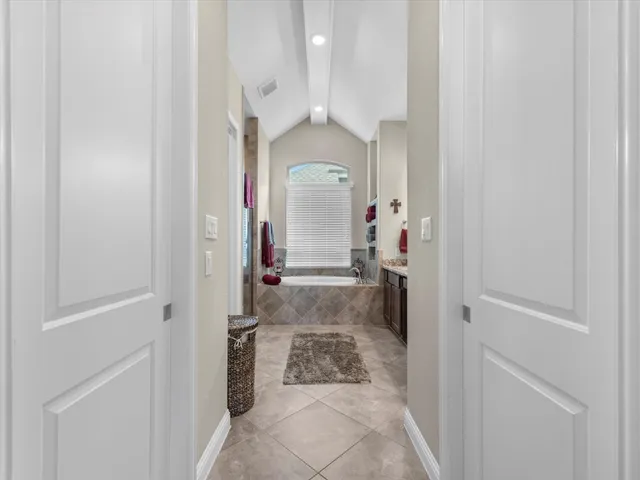 a bathroom with a granite countertop sink mirror and a bathtub