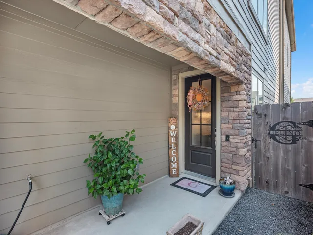 a vase with flowers sitting on a floor in front of a door
