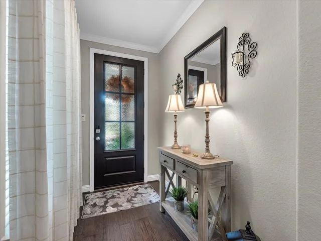 a view of an entryway with wooden floor