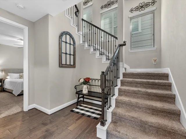 a view of entryway and hall with wooden floor
