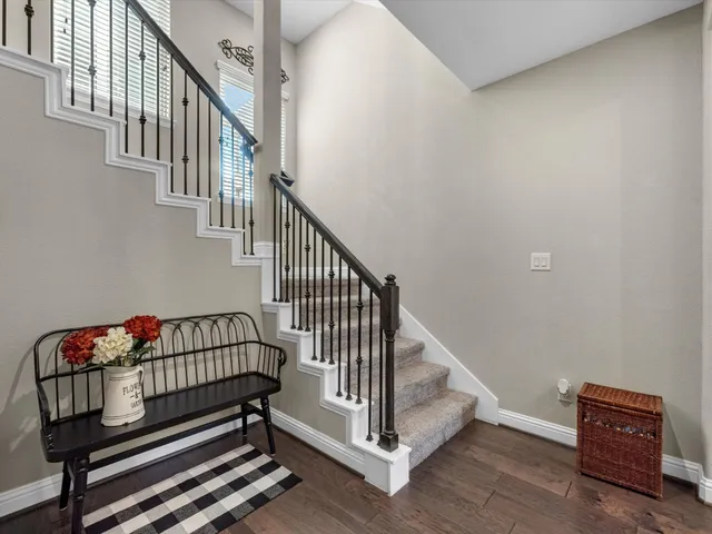 a view of staircase with lots of furniture and a window