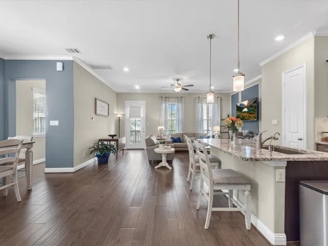 a very nice looking dining room with wooden floor and cabinets