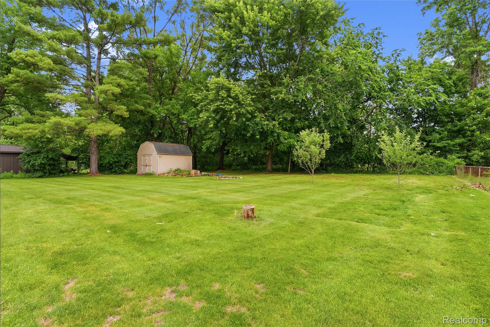 1843 Curtis Road Birch Run, MI 48415 - Photo 25 of 25 Expansive green lawn with a garden shed and mature trees