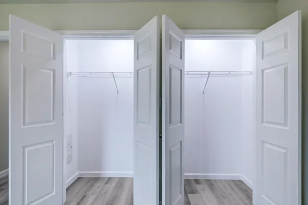 a view of walk in closet with wooden floor