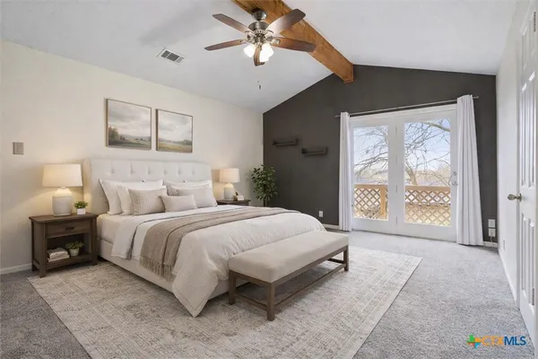 a spacious bedroom with a bed and a painting on the wall