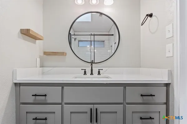 a bathroom with a sink and a mirror
