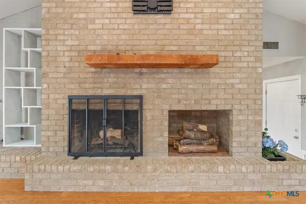 a view of a fireplace with wooden floor