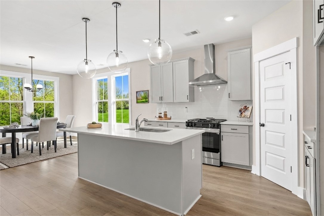 334 Summerall Drive Anderson, SC 29621 - Photo 2 of 28 This bright kitchen features a functional island and seamlessly flows into the dining area.