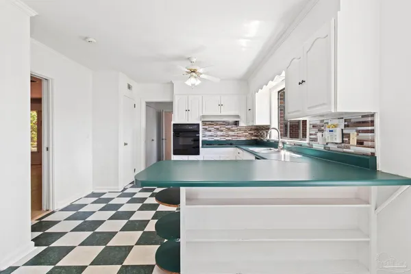 a view of a room with a black and white checkered floor