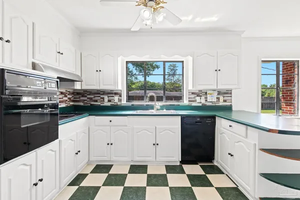 a kitchen with a cabinets and stainless steel appliances